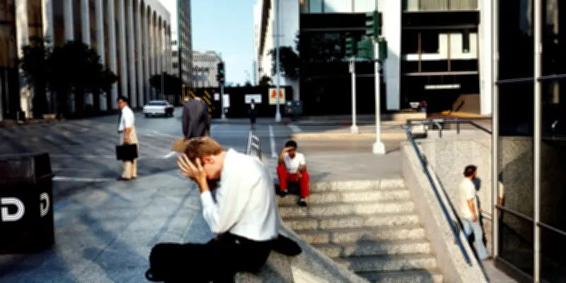 Le corps épuisé d'un homme face à ses responsabilités sur le béton