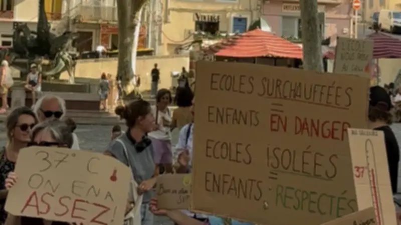 Parents en tenue de plage devant la mairie de Sète contre la chaleur dans les écoles